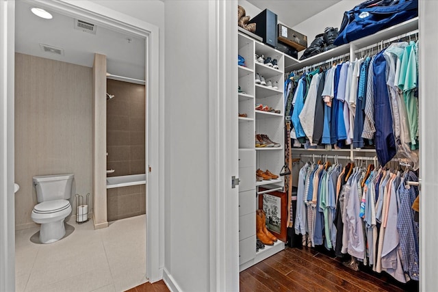 spacious closet with visible vents and wood finished floors