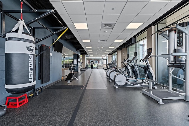 workout area featuring visible vents and a drop ceiling