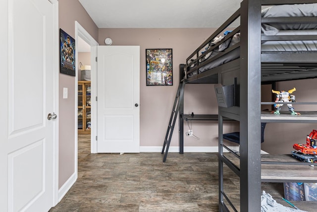 bedroom featuring baseboards and wood finished floors