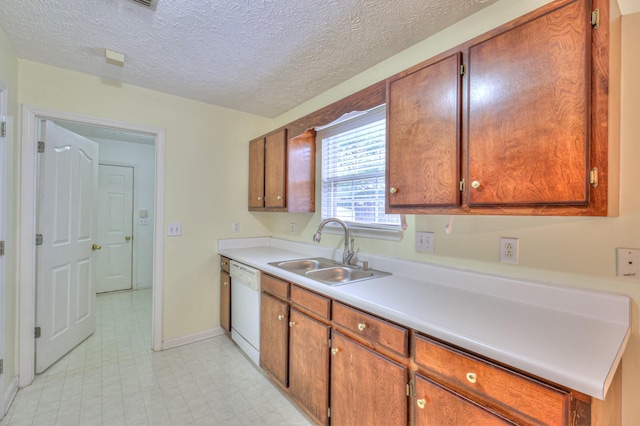 kitchen with brown cabinetry, light countertops, white dishwasher, and a sink