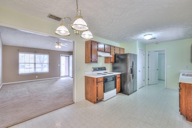 kitchen featuring white electric stove, under cabinet range hood, visible vents, light countertops, and stainless steel fridge with ice dispenser