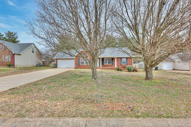 single story home with driveway, brick siding, and a front lawn