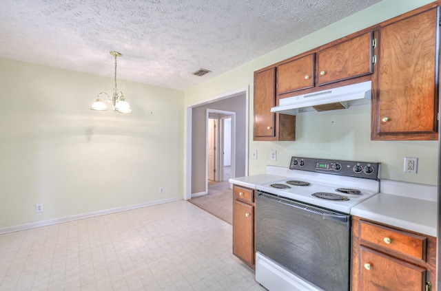 kitchen with visible vents, electric stove, brown cabinets, light countertops, and under cabinet range hood