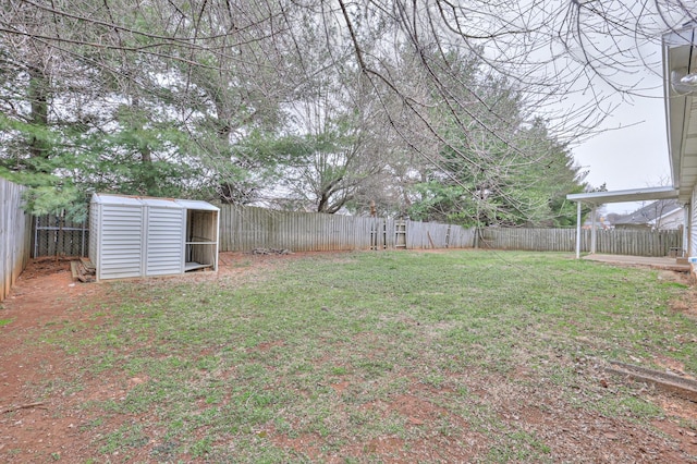 view of yard featuring a fenced backyard, an outdoor structure, and a storage shed