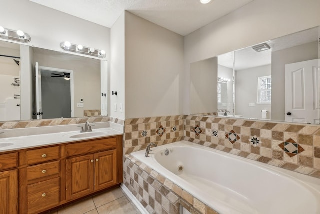 bathroom featuring a sink, visible vents, a bath, tile patterned floors, and double vanity