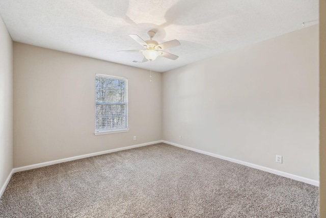 unfurnished room with a ceiling fan, carpet flooring, a textured ceiling, and baseboards