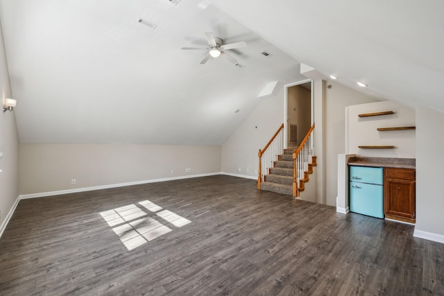 bonus room with stairs, dark wood finished floors, lofted ceiling, and baseboards