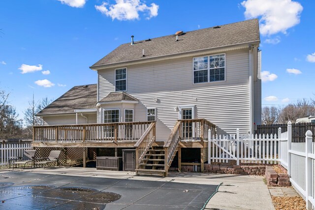 rear view of property with a fenced in pool, a patio, a fenced backyard, stairway, and a deck