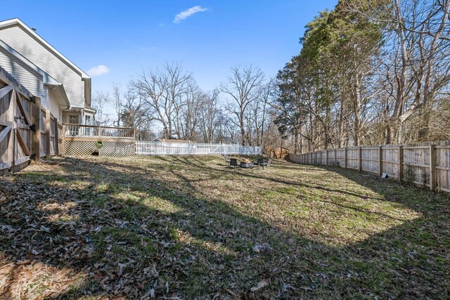 view of yard featuring a fenced backyard and a deck