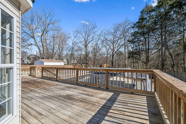 wooden terrace featuring an outdoor structure