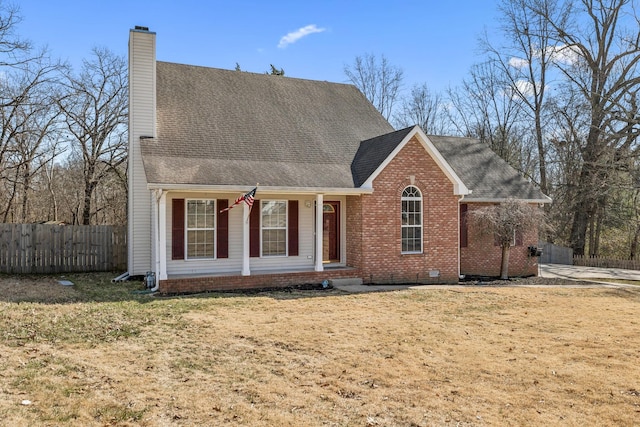 view of front of property featuring brick siding, fence, crawl space, a chimney, and a front yard