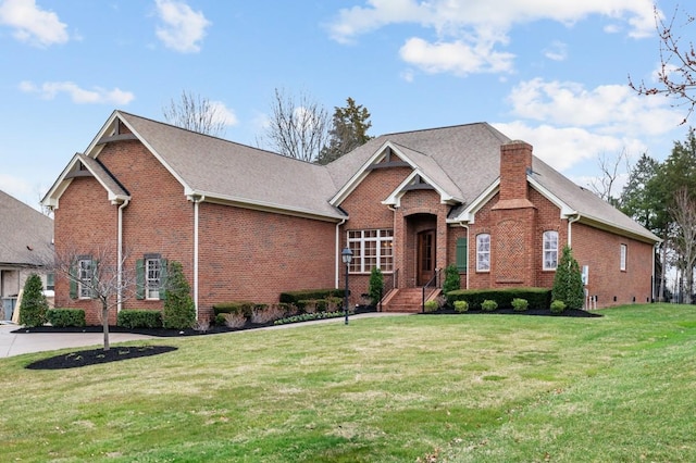 view of front facade with a front lawn and brick siding