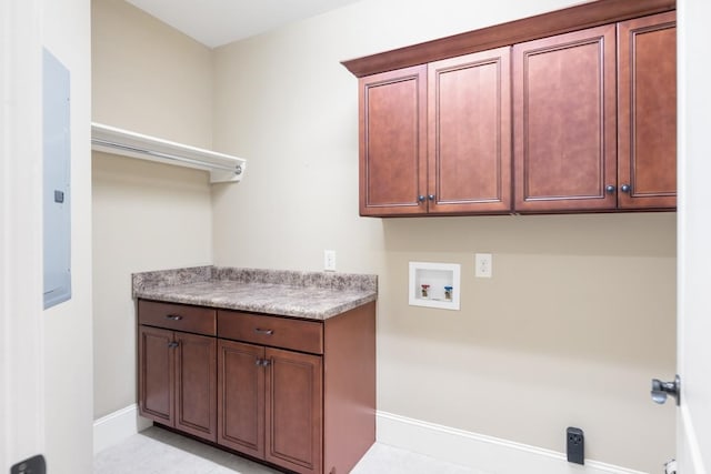 laundry room featuring hookup for a washing machine, cabinet space, and baseboards