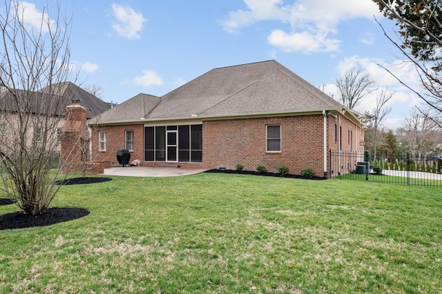 back of property with a yard, a patio area, fence, and brick siding