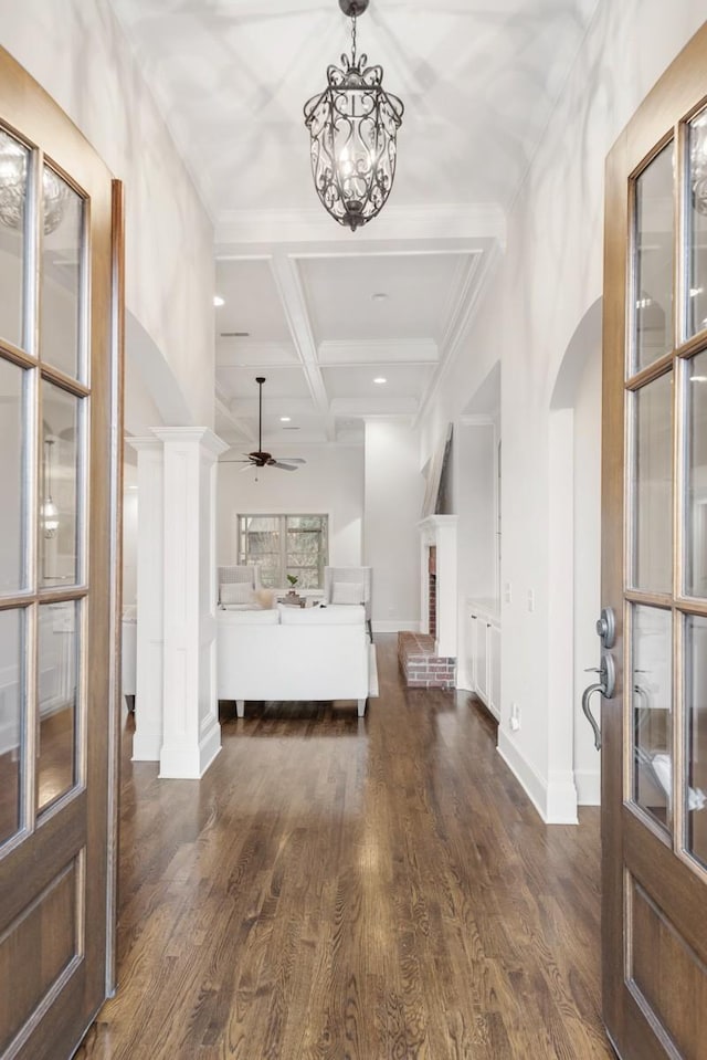 bedroom featuring arched walkways, coffered ceiling, baseboards, beamed ceiling, and dark wood finished floors