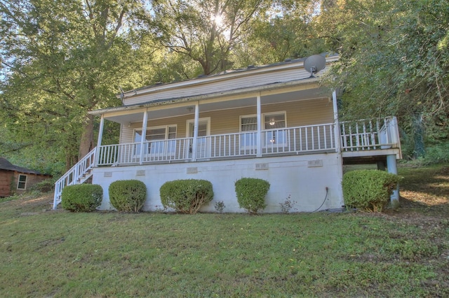 view of front of property with a porch and a front lawn