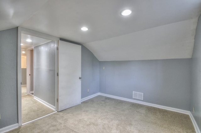 additional living space with baseboards, visible vents, vaulted ceiling, carpet floors, and recessed lighting