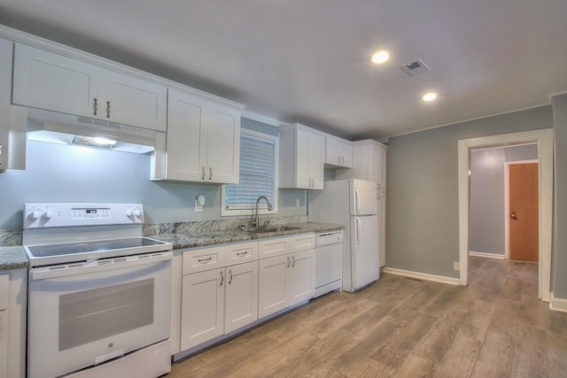 kitchen featuring under cabinet range hood, white appliances, a sink, white cabinetry, and visible vents