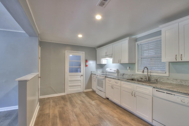 kitchen with visible vents, white cabinetry, a sink, light wood-type flooring, and white appliances