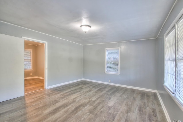 empty room featuring baseboards and wood finished floors