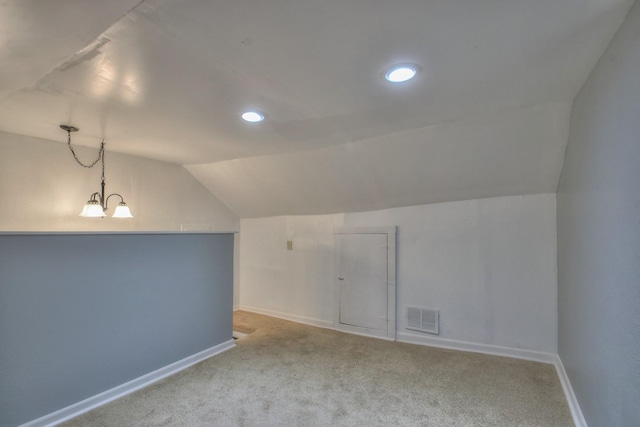 bonus room featuring carpet, visible vents, vaulted ceiling, a chandelier, and baseboards