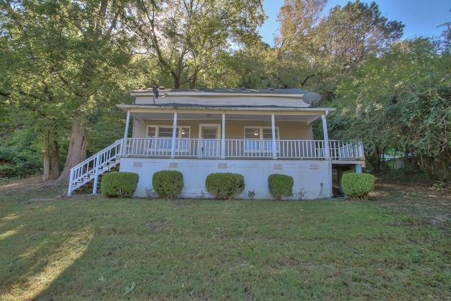 view of front facade with covered porch, stairs, and a front yard