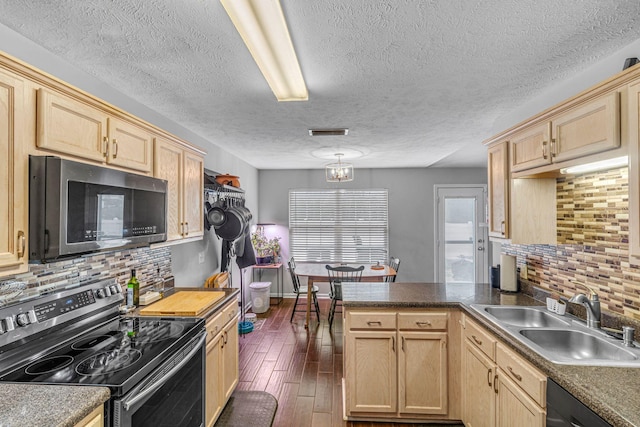 kitchen featuring dark wood-style flooring, visible vents, light brown cabinetry, appliances with stainless steel finishes, and a sink