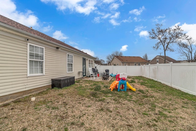 view of yard with a fenced backyard, a patio, and a fire pit