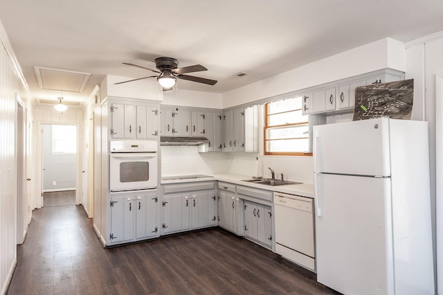 kitchen featuring white appliances, visible vents, decorative backsplash, dark wood-type flooring, and a sink