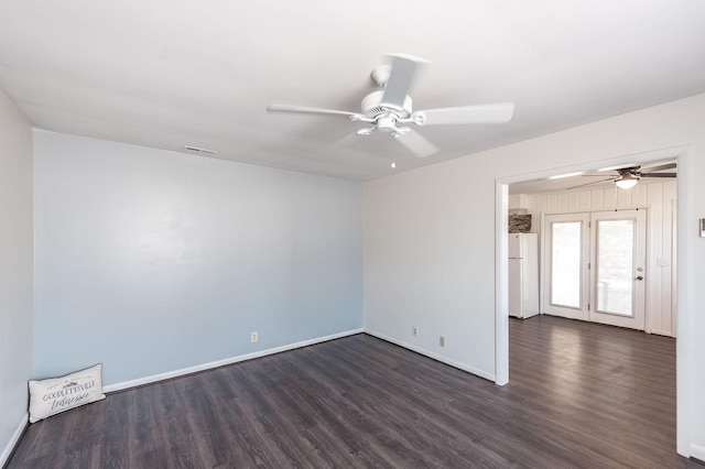 unfurnished room with ceiling fan, dark wood-style flooring, and baseboards