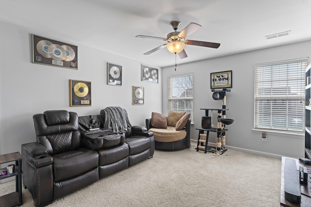 carpeted living area featuring visible vents, ceiling fan, and baseboards