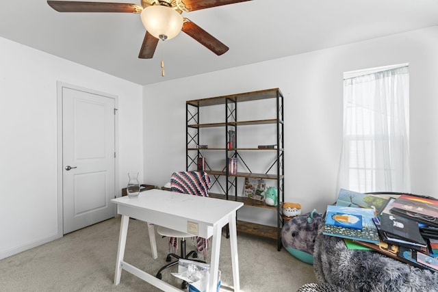 carpeted office featuring ceiling fan