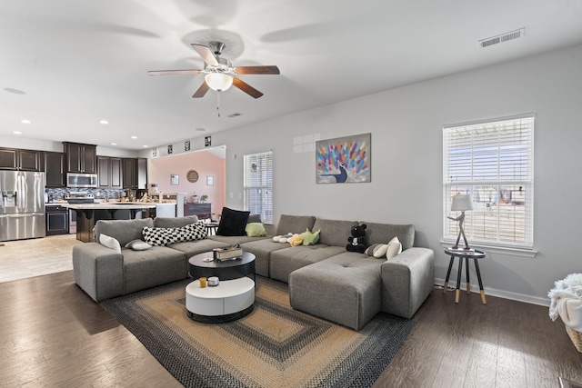 living area with recessed lighting, visible vents, light wood-style flooring, ceiling fan, and baseboards