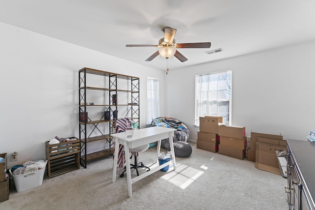 office with ceiling fan, carpet floors, and visible vents