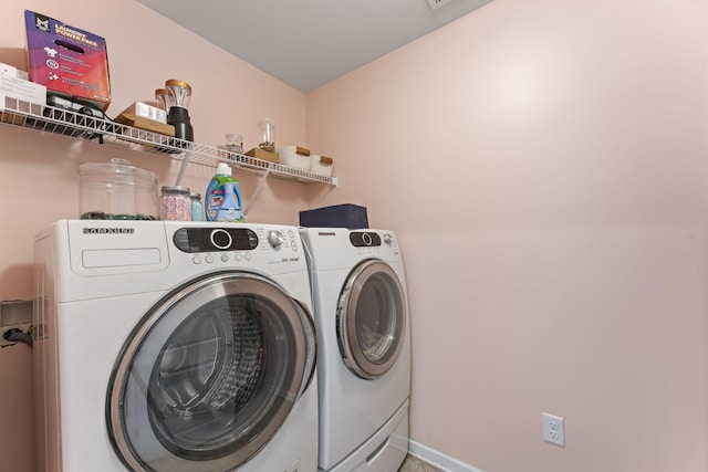 clothes washing area featuring washing machine and dryer and laundry area