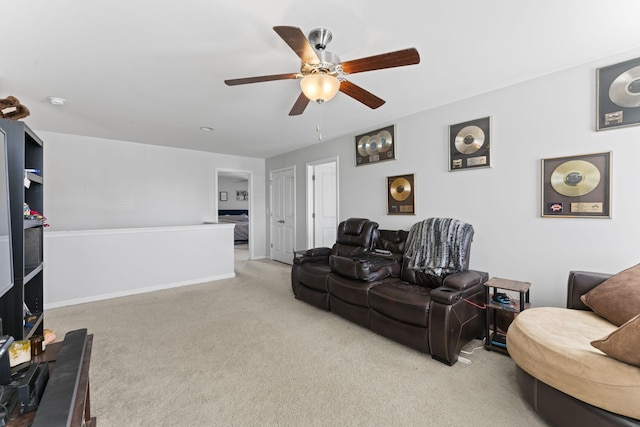 living area featuring a ceiling fan, carpet flooring, and baseboards