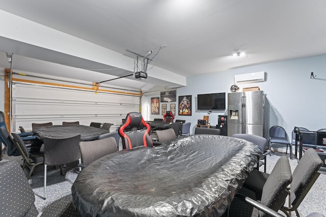 garage featuring stainless steel fridge with ice dispenser, a garage door opener, and a wall mounted air conditioner