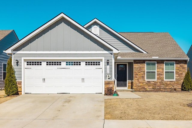 craftsman house with a garage, stone siding, a shingled roof, and concrete driveway