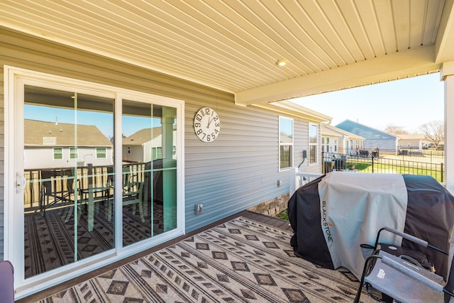 view of patio featuring a grill, a residential view, and fence