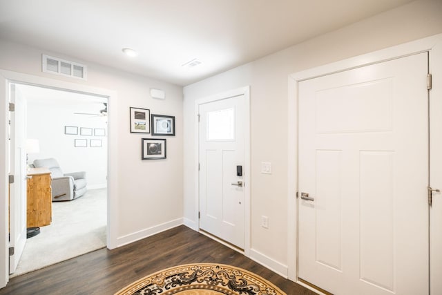 entrance foyer featuring baseboards, visible vents, ceiling fan, and dark wood-style flooring