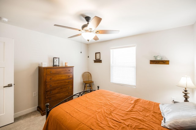 bedroom featuring light carpet, ceiling fan, and baseboards