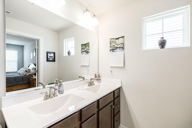 bathroom with a healthy amount of sunlight, a sink, and visible vents