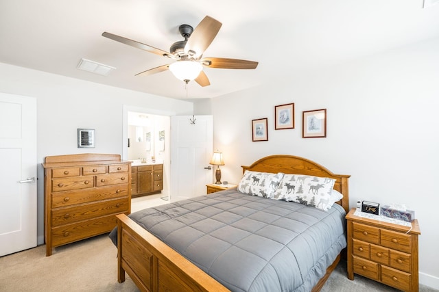 bedroom with light carpet, ceiling fan, connected bathroom, and visible vents