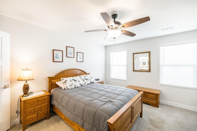 bedroom with visible vents, ceiling fan, light carpet, and baseboards