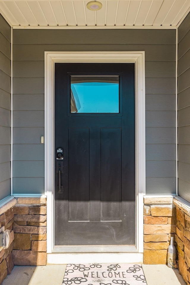 property entrance with stone siding