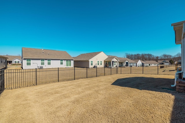 view of yard featuring a fenced backyard and a residential view