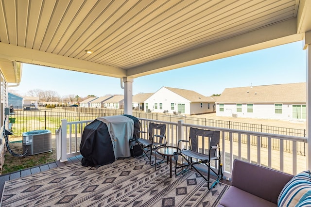 view of patio featuring central AC, a fenced backyard, a grill, and a residential view