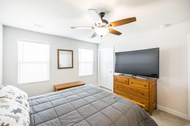 bedroom with a ceiling fan, carpet flooring, visible vents, and baseboards