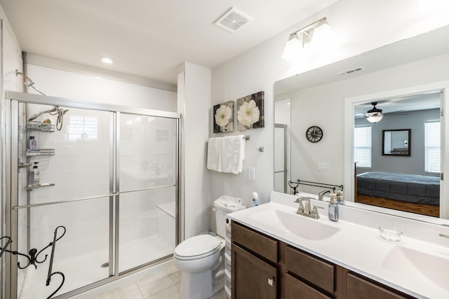 full bath with visible vents, a sink, a shower stall, and toilet