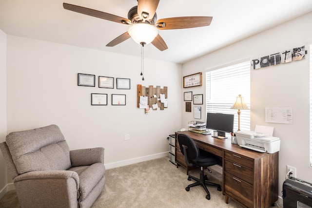 home office with light carpet, baseboards, and a ceiling fan